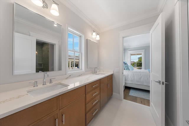 ensuite bathroom featuring double vanity, crown molding, a sink, and ensuite bathroom