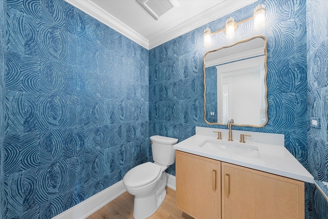 bathroom with wallpapered walls, visible vents, toilet, wood finished floors, and vanity