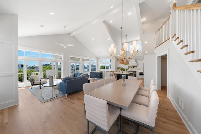 dining room featuring high vaulted ceiling, visible vents, stairs, beam ceiling, and light wood finished floors