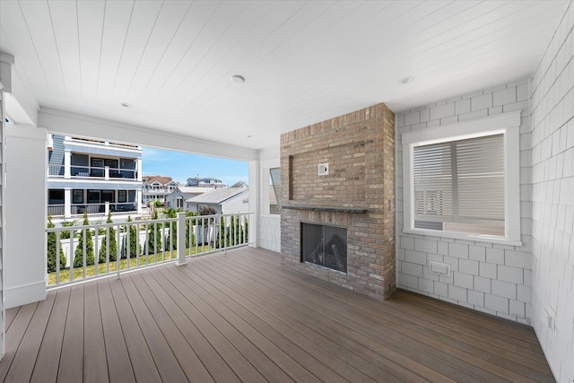 deck featuring an outdoor brick fireplace