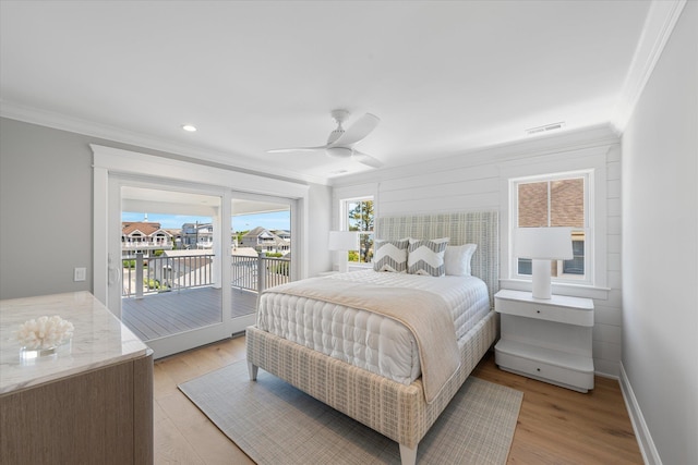 bedroom featuring light wood finished floors, visible vents, ornamental molding, access to outside, and baseboards