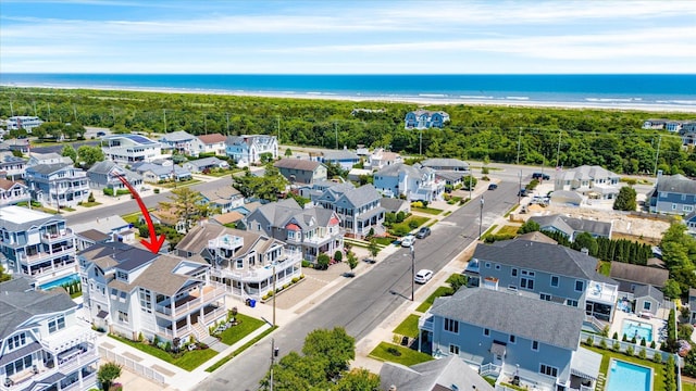 drone / aerial view with a residential view and a water view