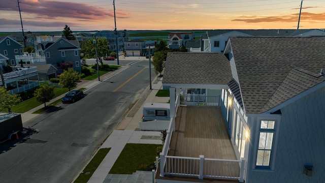 aerial view at dusk featuring a residential view