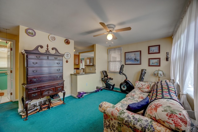 living area with ceiling fan and carpet flooring