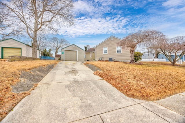 view of front of house featuring an outbuilding, a garage, and central AC