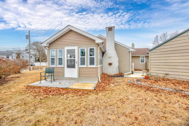 rear view of house featuring a yard and a patio area