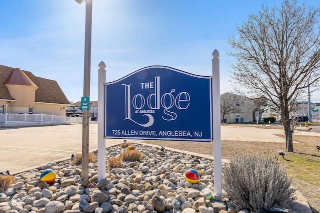 community sign featuring fence