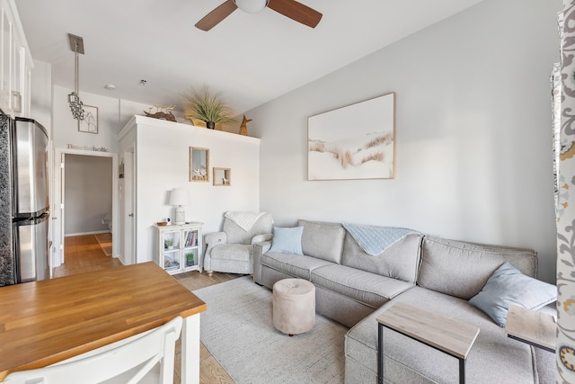 living room featuring a ceiling fan and wood finished floors