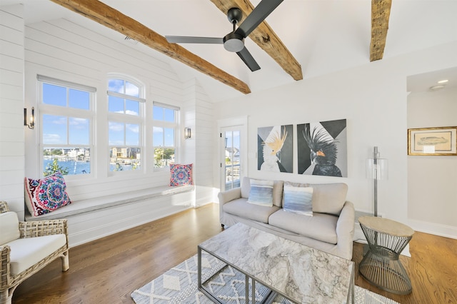 living room featuring vaulted ceiling with beams, hardwood / wood-style flooring, and ceiling fan