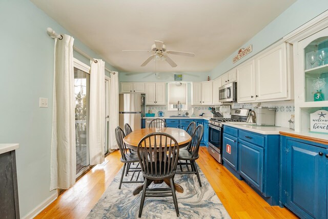 3817 Central Ave Unit 1St, Sea Isle City, NJ 08243 - kitchen with blue cabinetry, stainless steel appliances, ceiling fan, white cabinetry, and light wood finished floors