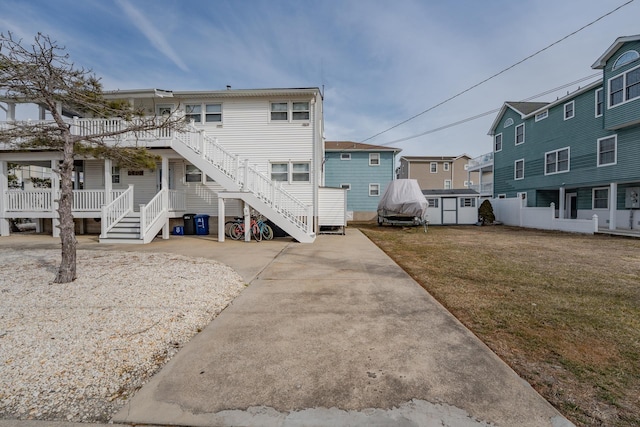 3817 Central Ave Unit 1St, Sea Isle City, NJ 08243 - rear view of property featuring stairway, a lawn, a residential view, and a wooden deck