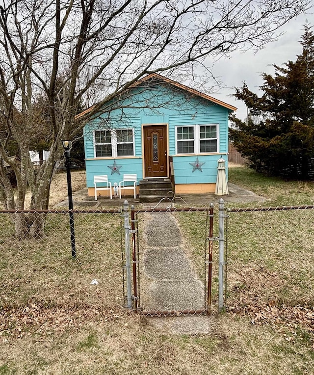 bungalow-style home featuring entry steps and fence