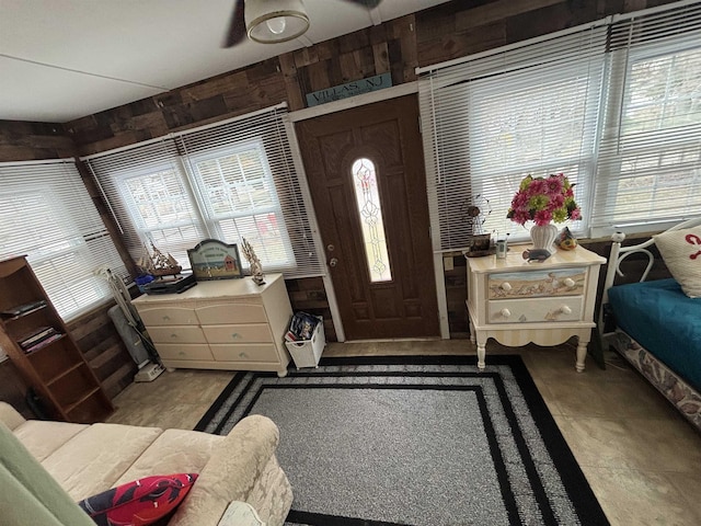 foyer with wooden walls
