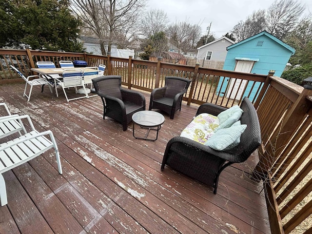 deck featuring outdoor lounge area, outdoor dining area, and fence