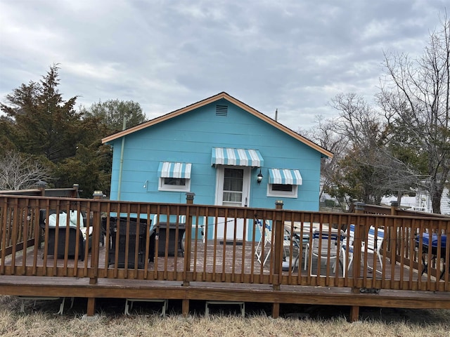 rear view of house featuring a deck