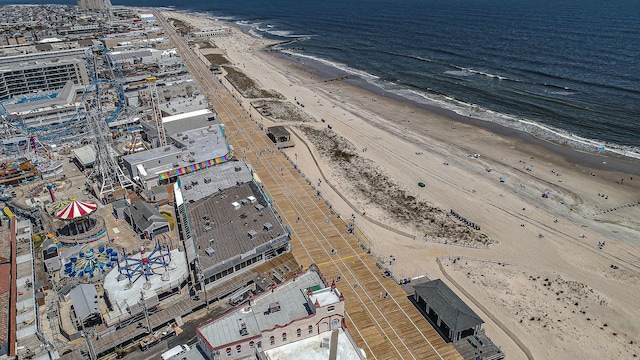 bird's eye view featuring a water view and a beach view