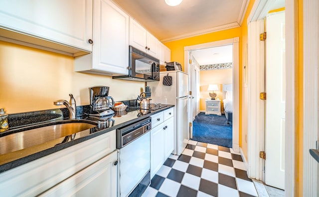 kitchen featuring a sink, white cabinets, tile patterned floors, black appliances, and crown molding