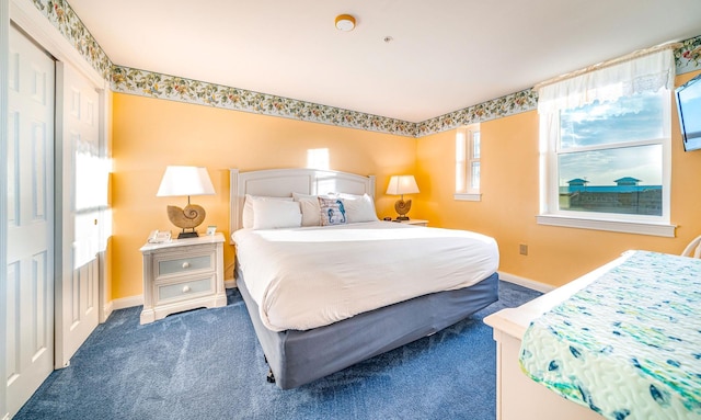 carpeted bedroom featuring baseboards