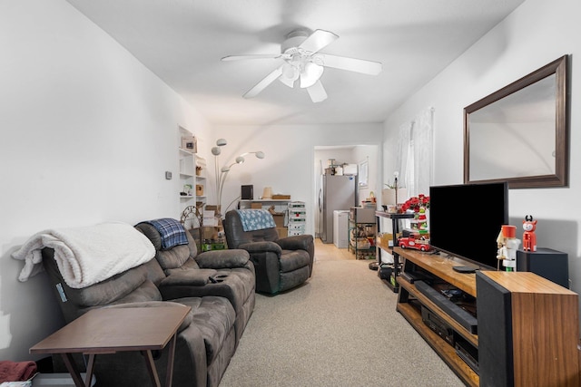 carpeted living room with ceiling fan