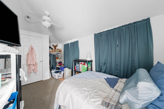 carpeted bedroom with ceiling fan and lofted ceiling