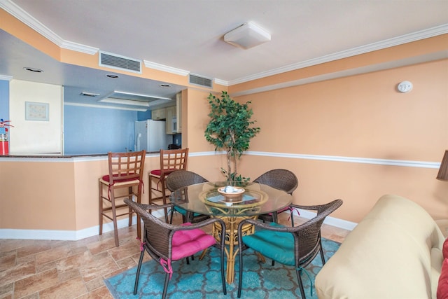 9905 Seapointe Blvd Unit 307, Lower Township, NJ 08260 - dining space with baseboards, ornamental molding, and stone finish floors