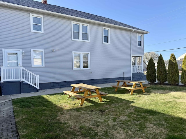 110 E 24th Ave Unit D, North Wildwood, NJ 08260 - back of house featuring a lawn and a chimney