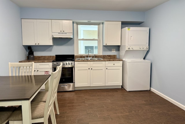 110 E 24th Ave Unit D, North Wildwood, NJ 08260 - kitchen with dark countertops, stainless steel stove, under cabinet range hood, a sink, and stacked washer / drying machine