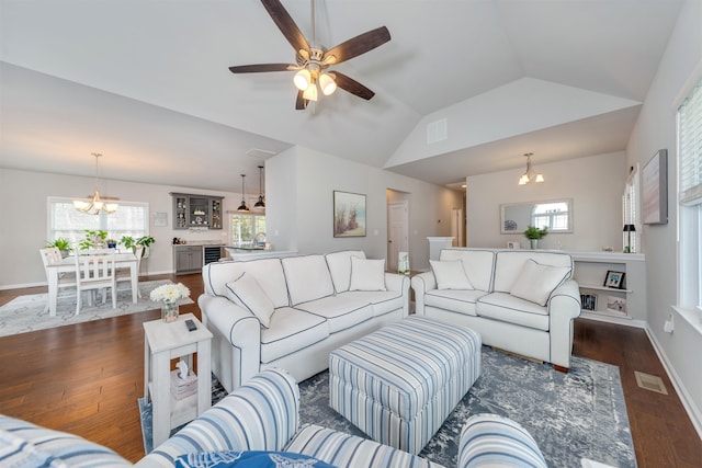 living area with visible vents, baseboards, dark wood-style flooring, and vaulted ceiling