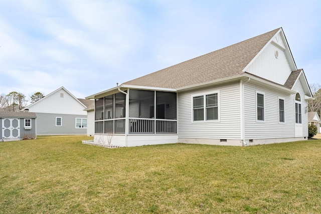 back of house featuring a sunroom, a storage shed, an outdoor structure, a yard, and crawl space