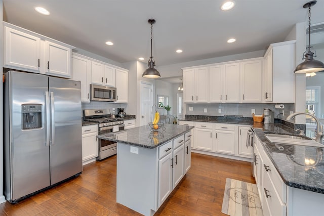 kitchen featuring a sink, dark wood finished floors, white cabinetry, and stainless steel appliances