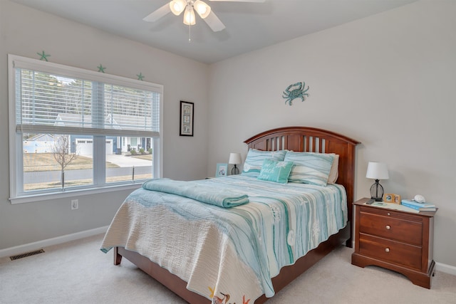 carpeted bedroom with a ceiling fan, baseboards, and visible vents