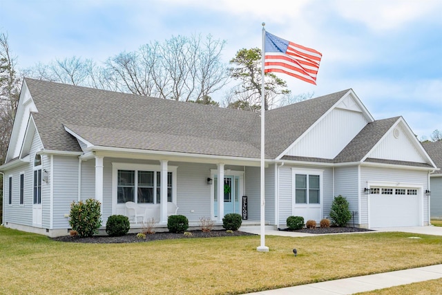 view of front facade featuring covered porch, an attached garage, a front lawn, and roof with shingles