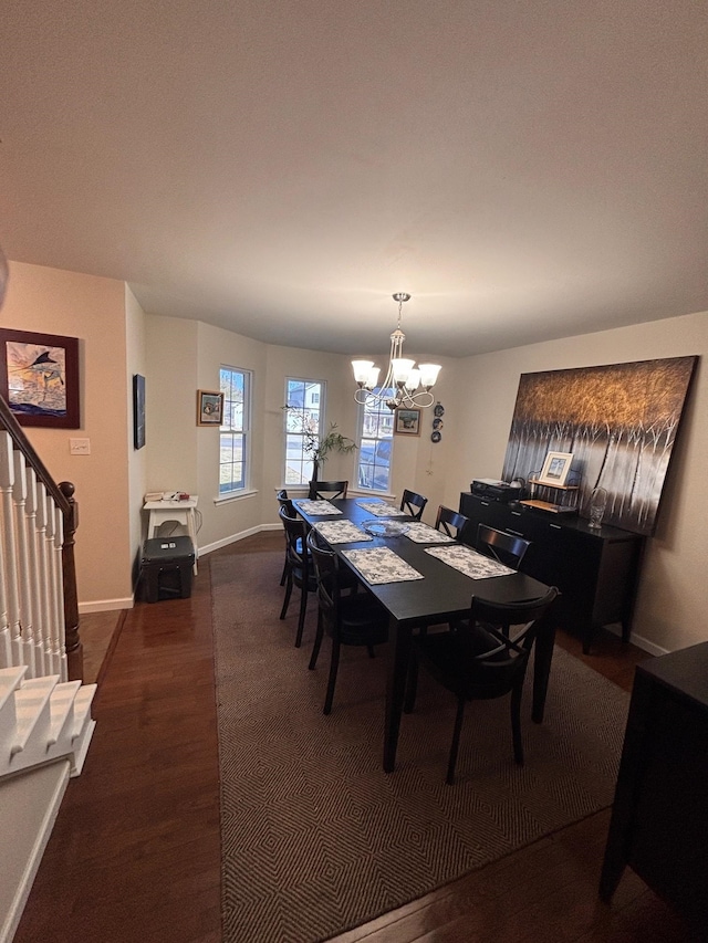 dining area featuring stairs, baseboards, a notable chandelier, and wood finished floors