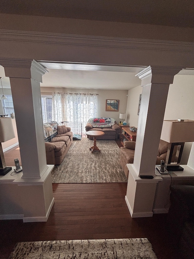 living room featuring wood finished floors and decorative columns