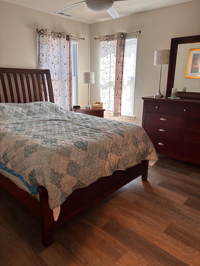 bedroom with wood finished floors and visible vents