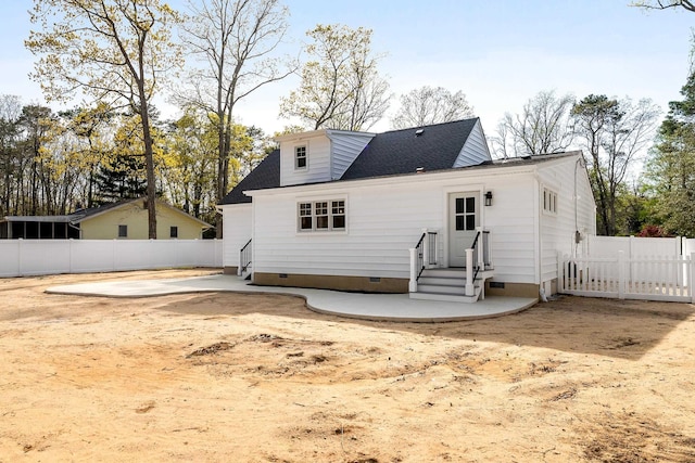 rear view of property with fence, a patio area, crawl space, and a shingled roof