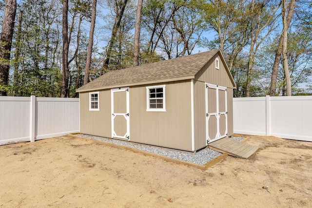 view of shed with a fenced backyard