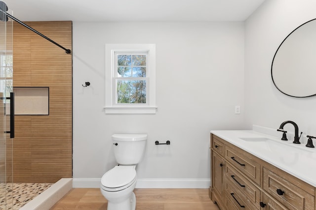 bathroom featuring baseboards, a shower stall, and plenty of natural light