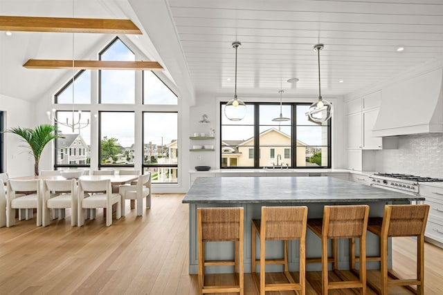 144 89th St, Stone Harbor, NJ 08247 - kitchen with a center island, healthy amount of natural light, light wood-style floors, white cabinetry, and recessed lighting