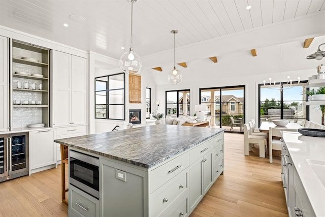 144 89th St, Stone Harbor, NJ 08247 - kitchen featuring open floor plan, stainless steel microwave, healthy amount of natural light, light wood-style floors, and wooden ceiling