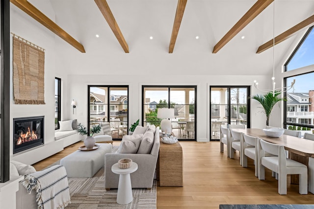 144 89th St, Stone Harbor, NJ 08247 - living room with beam ceiling, a glass covered fireplace, light wood-style flooring, and high vaulted ceiling