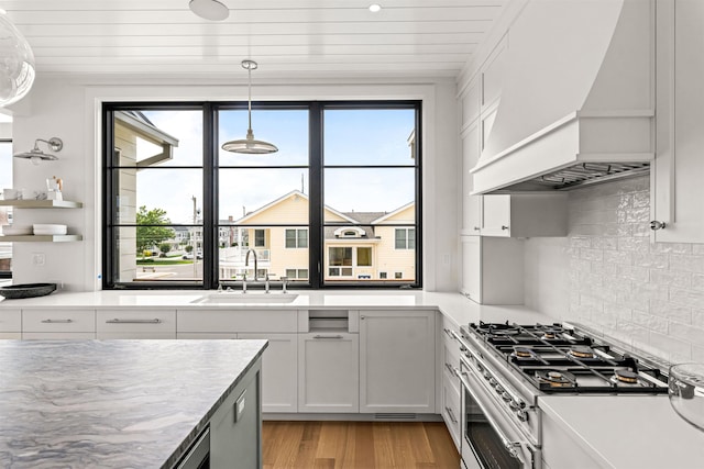 144 89th St, Stone Harbor, NJ 08247 - kitchen with premium range hood, stainless steel stove, light wood-type flooring, light countertops, and wooden ceiling