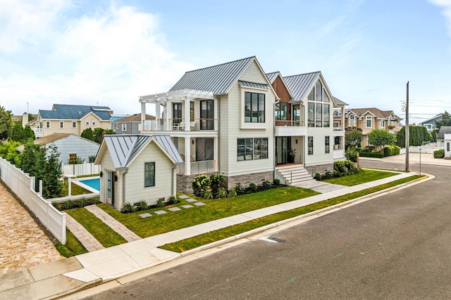 144 89th St, Stone Harbor, NJ 08247 - view of front of house featuring a standing seam roof, a metal roof, a pergola, a residential view, and a balcony