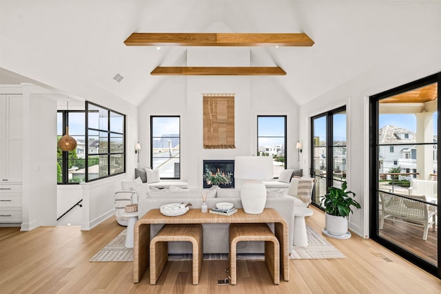 144 89th St, Stone Harbor, NJ 08247 - living area featuring beam ceiling, light wood-style flooring, high vaulted ceiling, and a glass covered fireplace