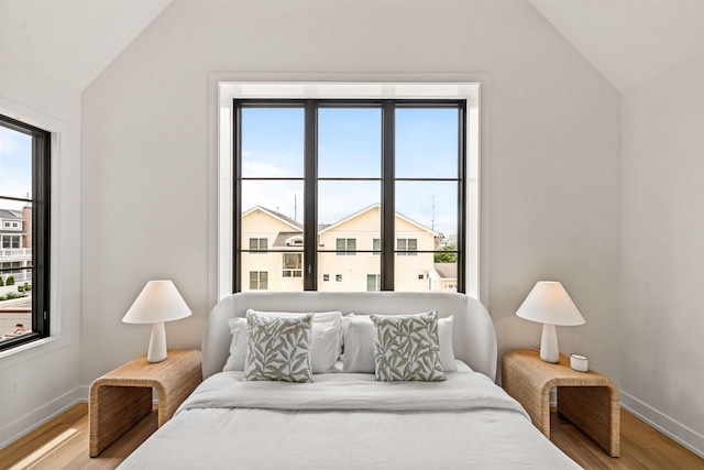 144 89th St, Stone Harbor, NJ 08247 - bedroom featuring lofted ceiling, light wood-type flooring, and multiple windows