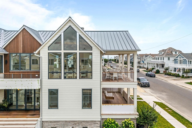 144 89th St, Stone Harbor, NJ 08247 - back of house featuring a standing seam roof, a metal roof, and a residential view