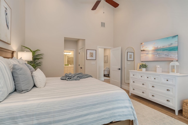 202 Osprey Dr Unit 202, Cape May Court House, NJ 08210 - bedroom featuring light wood finished floors, a towering ceiling, ensuite bath, and ceiling fan
