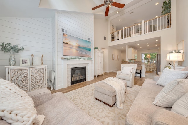 202 Osprey Dr Unit 202, Cape May Court House, NJ 08210 - living area with high vaulted ceiling, ceiling fan, light wood-style flooring, a glass covered fireplace, and recessed lighting