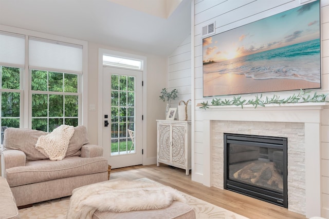 202 Osprey Dr Unit 202, Cape May Court House, NJ 08210 - living room featuring lofted ceiling, wood finished floors, and a glass covered fireplace