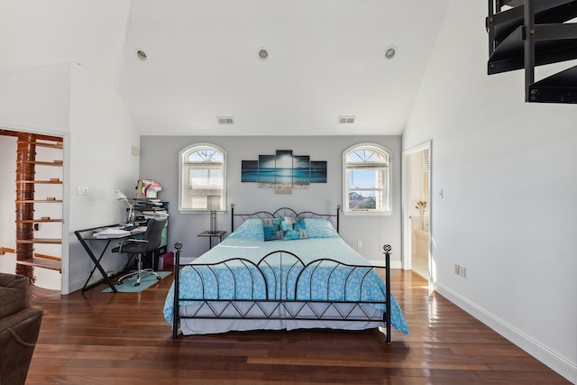 bedroom with multiple windows, lofted ceiling, and dark hardwood / wood-style floors